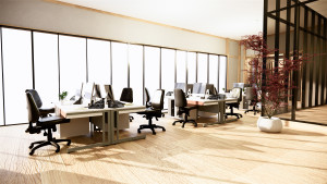 Open office setting with computers, desks and chairs.